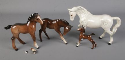 A collection of Beswick and Royal Doulton horses including dapple grey example. Grey example has