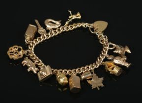 A 9ct gold charm bracelet with mostly 9ct gold charms. Gross weight 36.54g.