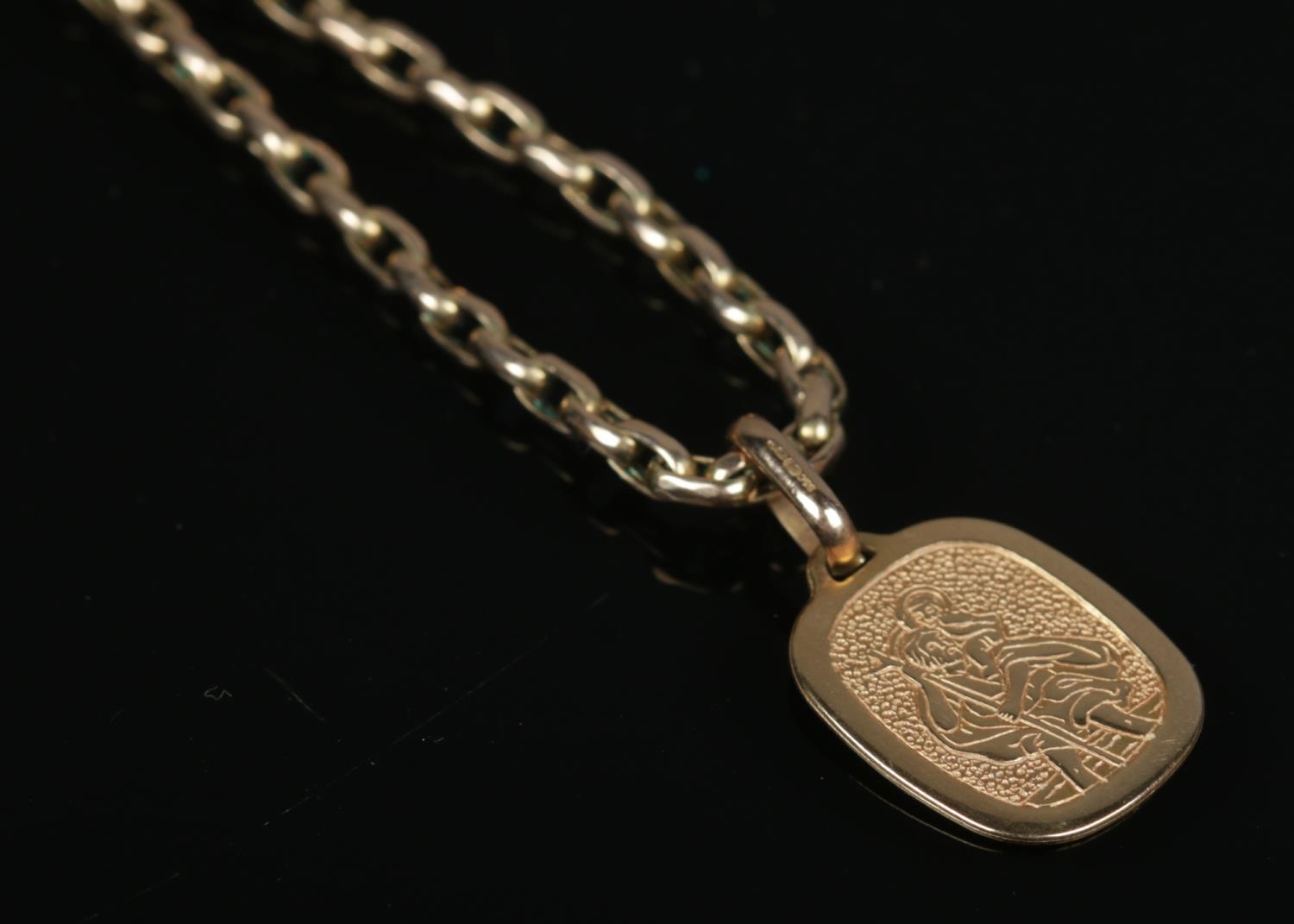 A 9ct gold rolo link necklace with 9ct gold St Christopher pendant. Length of chain 50cm. 13.04g.