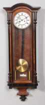 A 19th century walnut Vienna twin weight wall clock. Having enamel dial and Roman numeral markers.