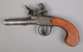 A 19th century flint lock pistol with cylindrical screw off barrel. Stamped with indistinct makers