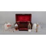 An early 19th century mahogany apothecary box with contents of glass medicine and poison bottles.