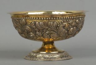 A late 19th century silver gilt pedestal bowl with repousse decoration. London assay marks for