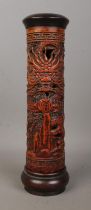 A Chinese wooden incense holder with carved decoration depicting dragons. Height 25cm.