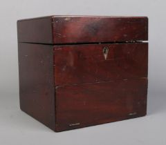 An early 19th century mahogany apothecary cabinet with contents of various glass medicine and poison