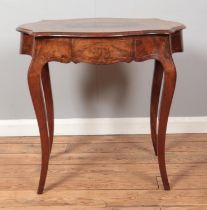 A Victorian walnut table, with single drawer and marquetry inlay decoration. Raised on cabriole