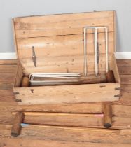 A vintage ash and cast iron croquet set house in pine chest with cast iron handles marked S&S.