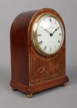 A small Edwardian brass inlaid mahogany dome top mantel clock. The dial marked for Edmond Johnson