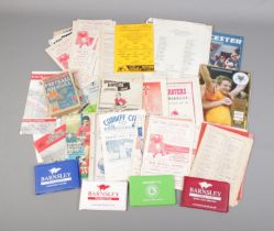 A box of Barnsley Football programmes and ephemera to include 1980's season ticket books,