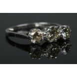 An 18ct white gold and platinum three stone diamond ring. Total diamond approximately 1.25ct (centre