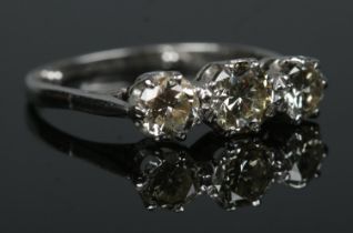 An 18ct white gold and platinum three stone diamond ring. Total diamond approximately 1.25ct (centre