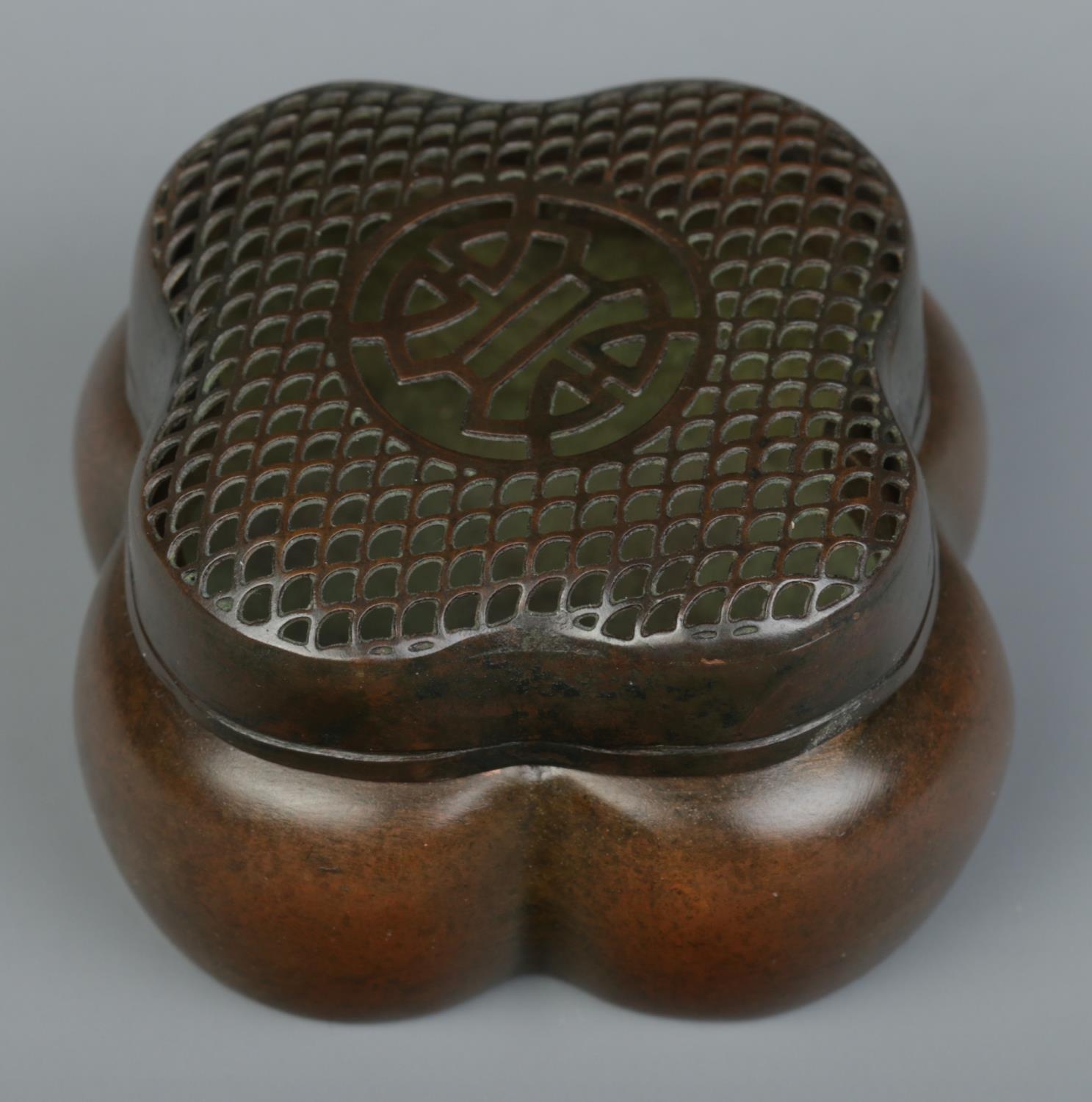 A Chinese bronze hand warmer of lobed form, having pierced cover. Character marks to base. 4cm x 6. - Image 2 of 3