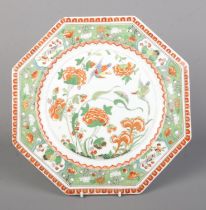 A Rockingham octagonal plate decorated in the famille vert palette with birds and peonies.