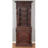 An extensively carved oak Flemish style cabinet. Having glazed top and cupboard base. Height