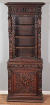 An extensively carved oak Flemish style cabinet. Having glazed top and cupboard base. Height