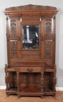 An extensively carved oak hall stand. Height 216cm, Width 123cm, Depth 42cm.