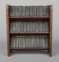 A miniature bookshelf with contents of Allied Newspaper Ltd William Shakespeare volumes. Bookshelf