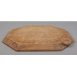 Robert 'Mouseman' Thompson, an oak cheese board with signature mouse carving. 31cm x 26cm.