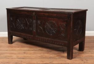 A period carved and panelled oak coffer. 60cm x 118cm x 43cm.