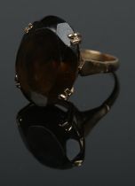 A gold ring set with large oval cut smokey quartz stone. Size O½, total weight 6.2g. Hallmarked