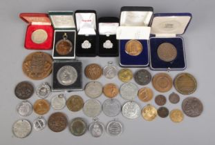 A quantity of mainly medals and commemorative plaques. To include Cunard studs, 'The smallholder