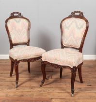 A pair of Victorian carved mahogany parlour chairs.