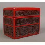 A Chinese cinnabar lacquer card box. The cover decorated with a landscape scene. 9cm x 11cm x 6.5cm.
