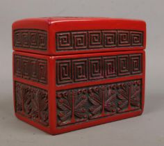 A Chinese cinnabar lacquer card box. The cover decorated with a landscape scene. 9cm x 11cm x 6.5cm.