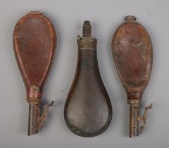 Two antique leather shot pouches along with a Cutts Patent powder flask. Both leather examples