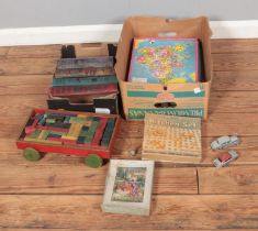 Two boxes of assorted children's toys and annuals to include diecast vehicles, Collin's Children's