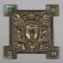 A Victorian bronze relief plaque of a woman's face surrounded by foliage. Bears lozenge mark to