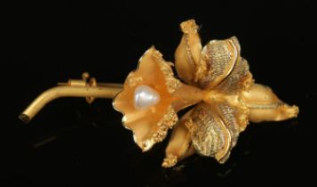 An 18ct brooch formed as a flower and set with single freshwater pearl. Total weight 8.5g.