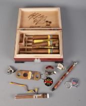 A collection of smoking items to include cigars, pipes, lighters, etc.