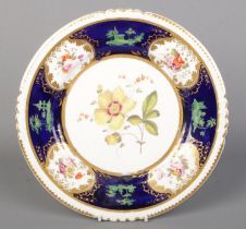 A Rockingham dessert plate hand painted with floral sprays with cobalt blue and gilt borders. Puce