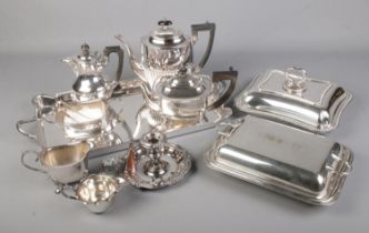 A good collection of silver plate including several tea pots, jugs, tureens, tray, candle holder &