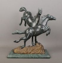A Verdi Gris bronze sculpture modelled as two frolicking horses raised on marble base. Height 30.