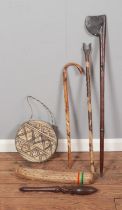 A collection of mostly tribal wares to include rain stick, hide drum, axe, walking stick , etc.