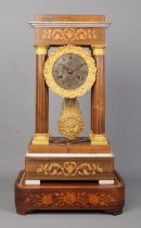 A 19th century French inlaid rosewood Portico clock. Height on stand 47.5cm.