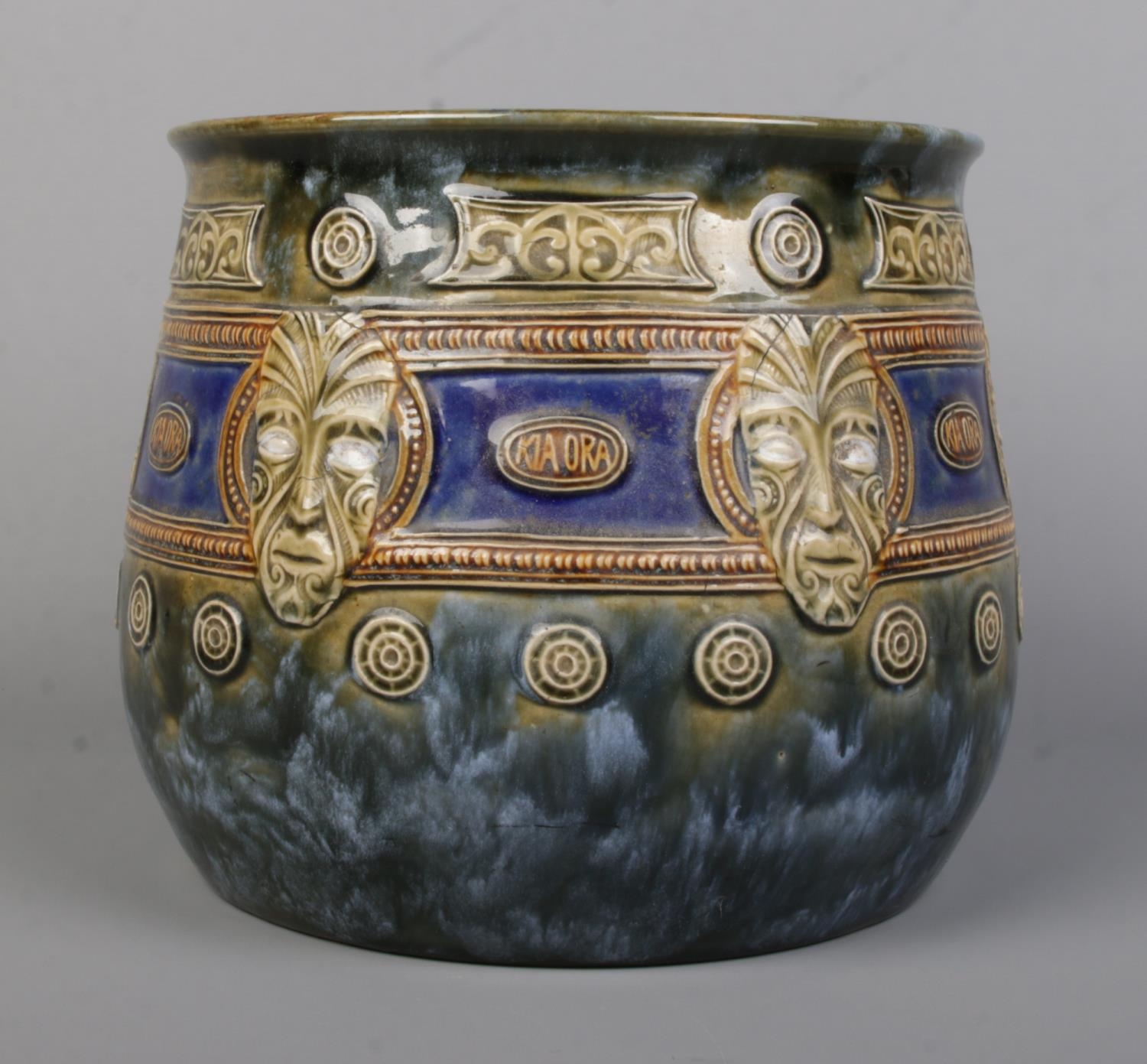 An early 20th century Royal Doulton Maori Ware glazed stoneware jardiniere. Decorated with mask