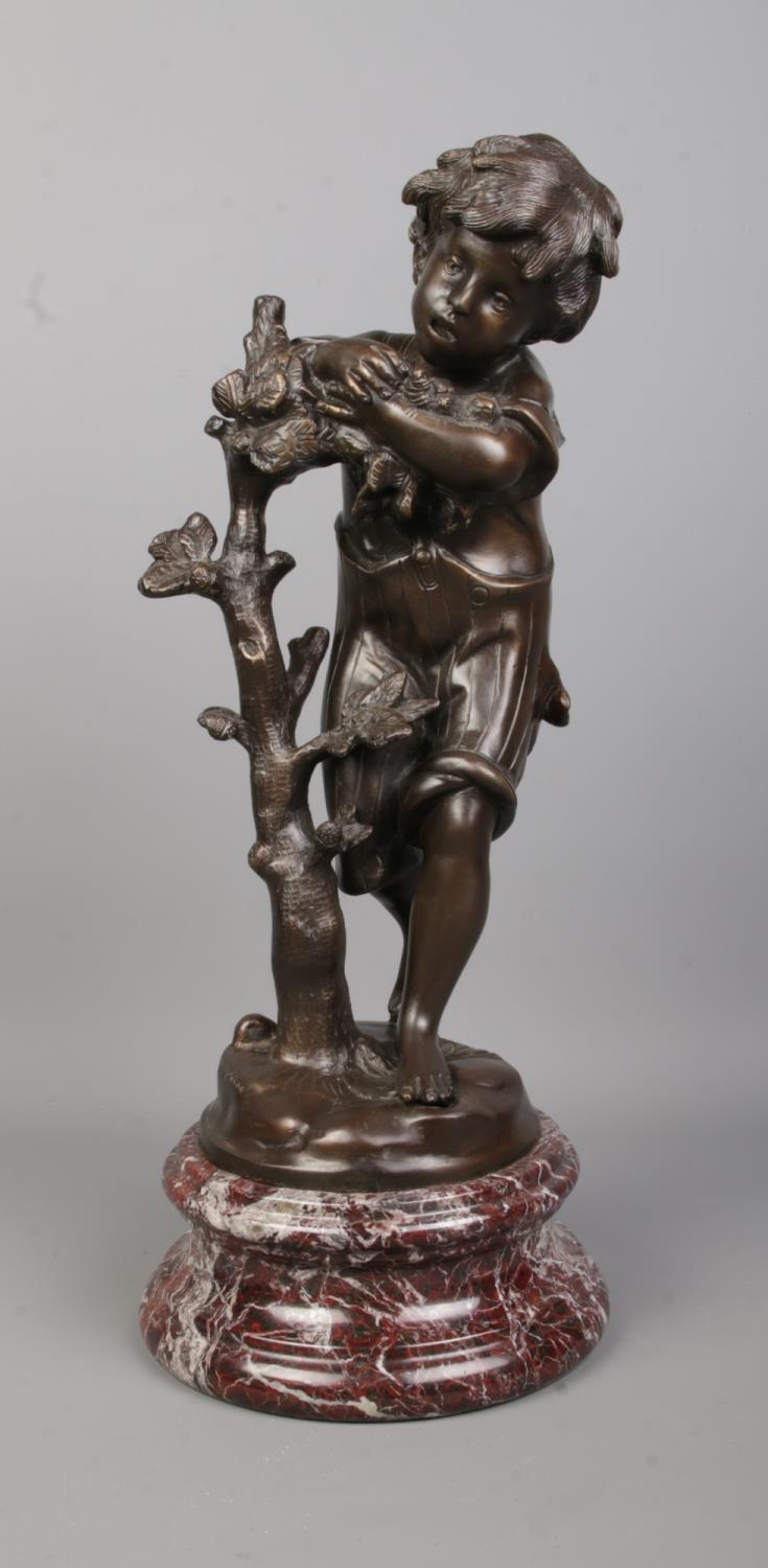 After Auguste Moreau, a bronze sculpture of a boy next to a tree, raised on marble base. Signed to