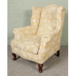 A 20th century upholstered armchair