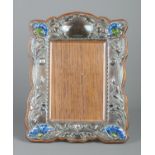 An Art Nouveau silver mounted easel photograph frame. Decorated in relief with flowers and having