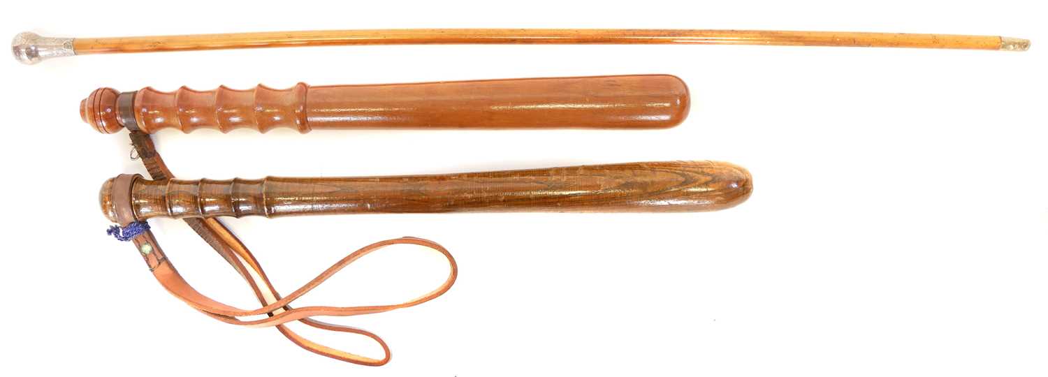 Two truncheons, one stamped W96, together with a silver topped swagger stick bearing London 1914