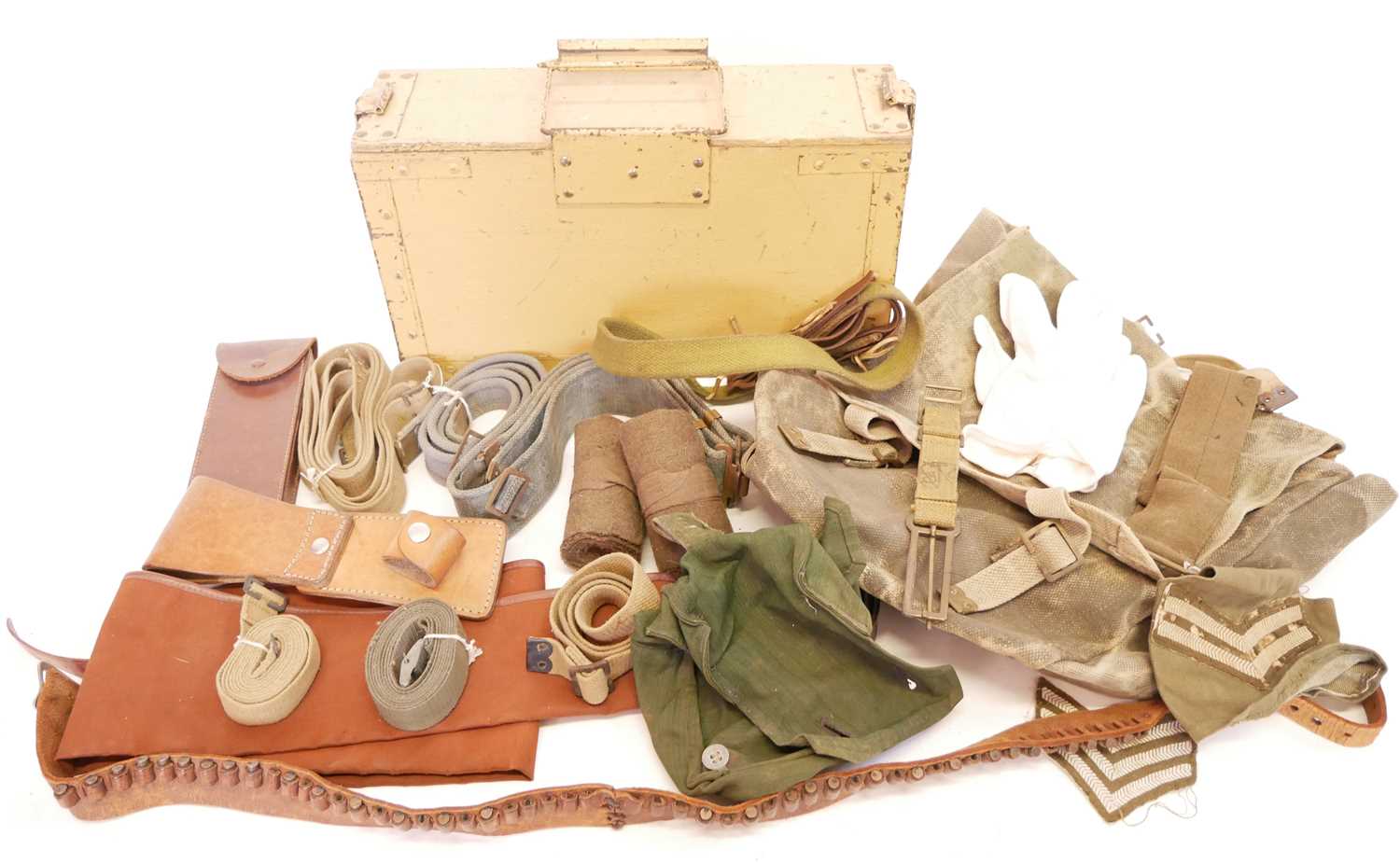 Collection of military items, including a kit rucksack, gun slip, leather and webbing belts, two