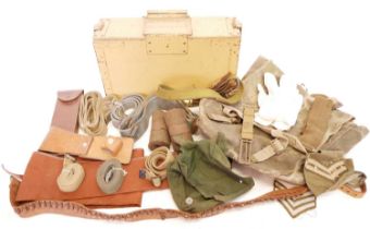 Collection of military items, including a kit rucksack, gun slip, leather and webbing belts, two