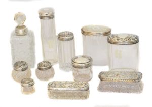 A selection of silver lidded jars,