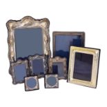 A selection of silver fronted photo frames,