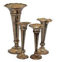 Four silver trumpet vases,