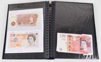 Twenty-five Bank of England banknotes in an album (25).