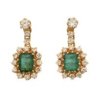 A pair of emerald and diamond earrings.